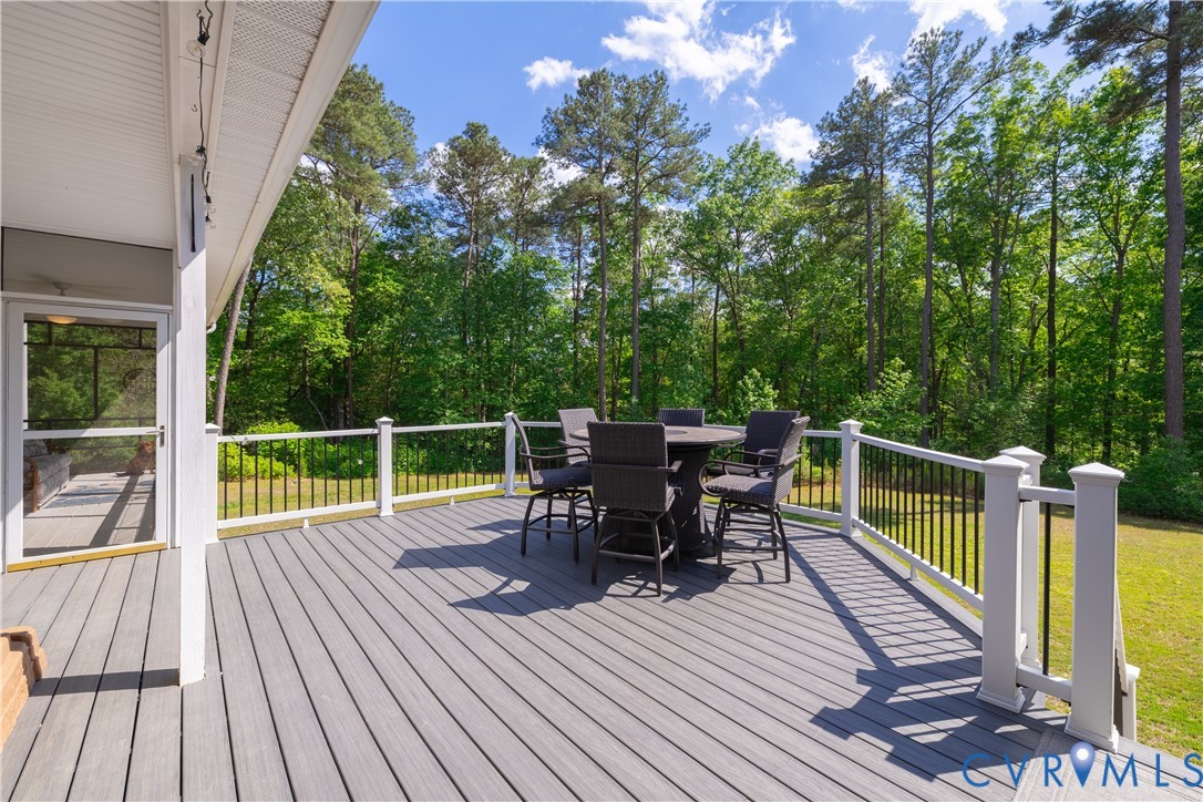 4789 Tatum Road Disputanta, VA 23842 - Photo 33 of 46 a view of a deck with chairs and wooden floor