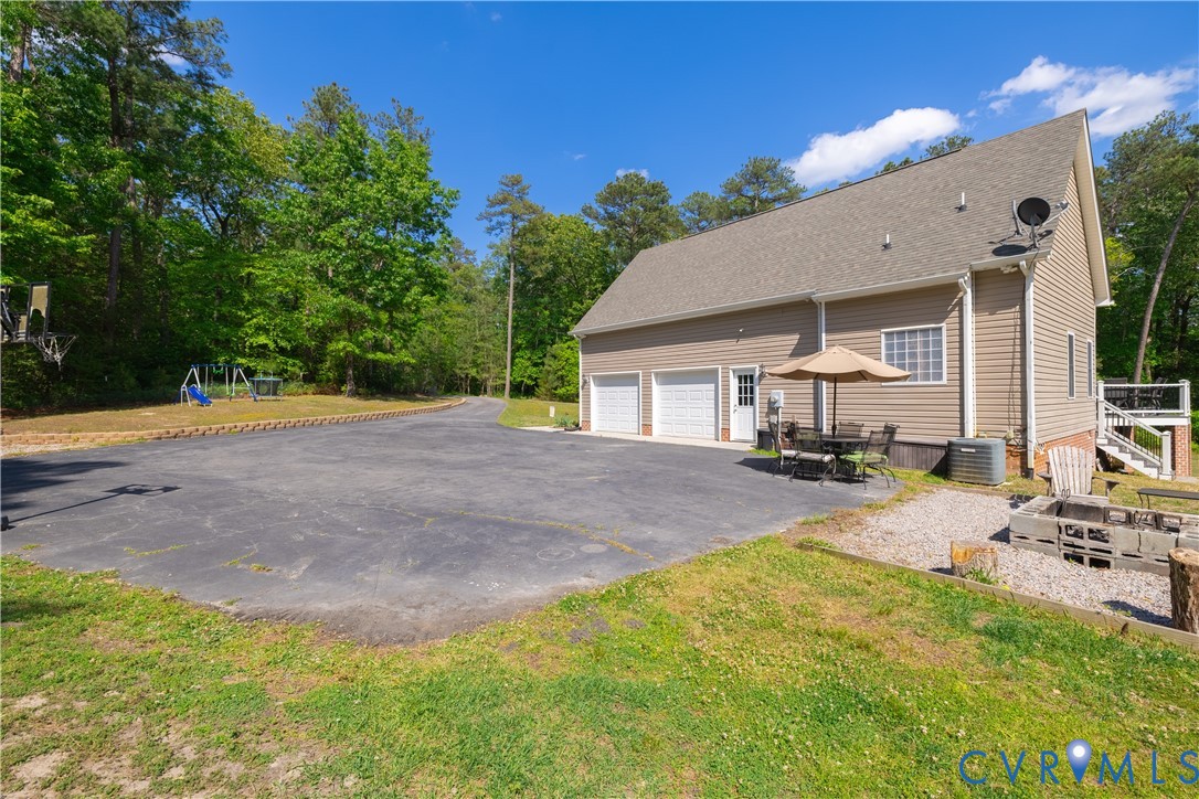 4789 Tatum Road Disputanta, VA 23842 - Photo 40 of 46 a view of a house with backyard and sitting area