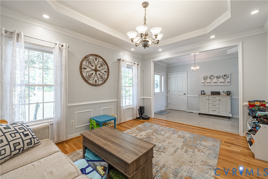 4789 Tatum Road Disputanta, VA 23842 - Photo 6 of 46 a living room with furniture a chandelier and a window