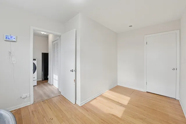 a view of hallway with wooden floor