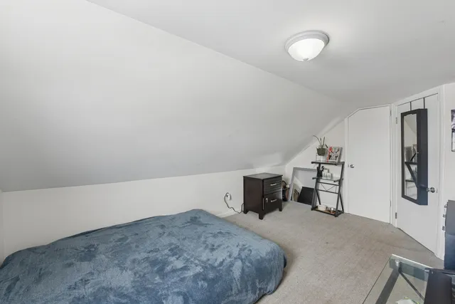 a bedroom with a bed and dresser