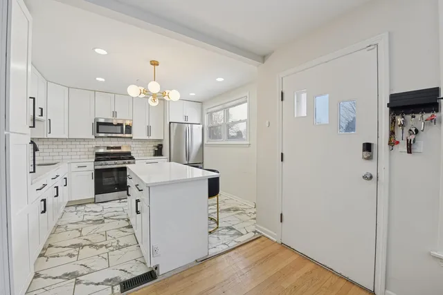 a kitchen with granite countertop a sink stove and refrigerator
