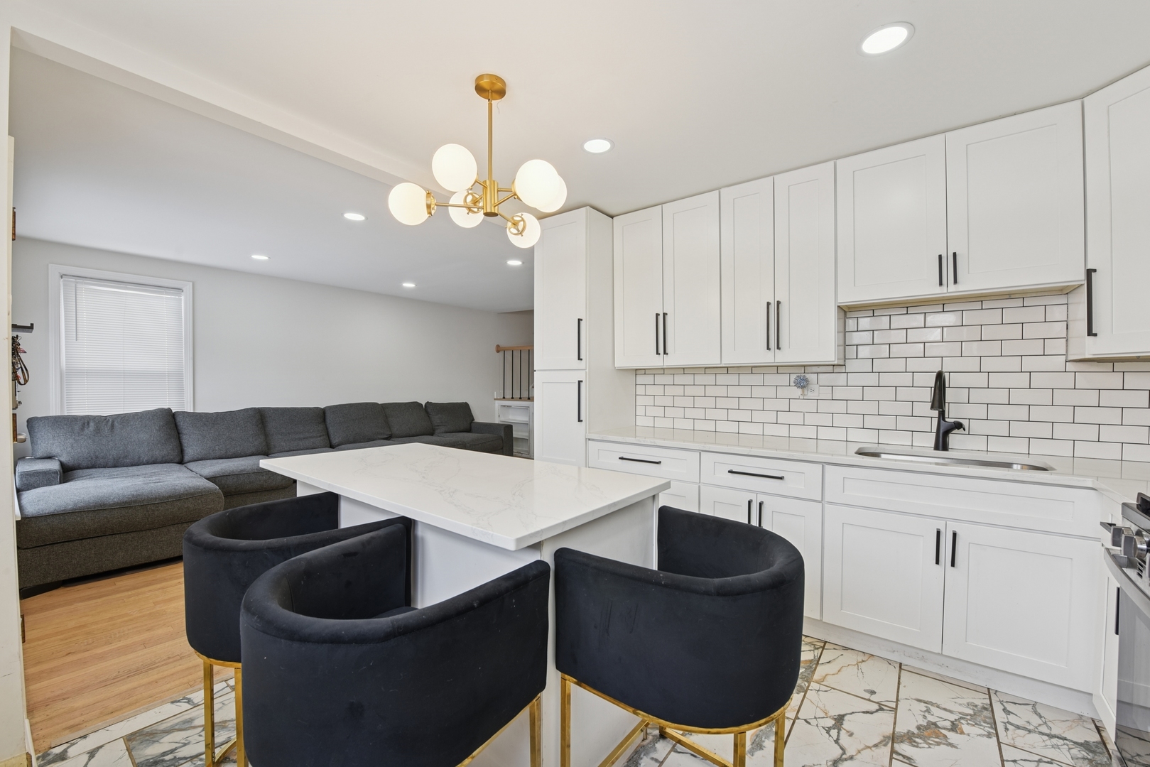 4137 Ruby Street Schiller Park, IL 60176 - Photo 7 of 24 a kitchen with a table chairs sink and cabinets