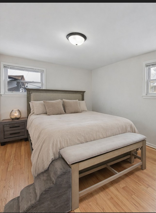 4137 Ruby Street Schiller Park, IL 60176 - Photo 8 of 24 a bedroom with a bed and a night stand