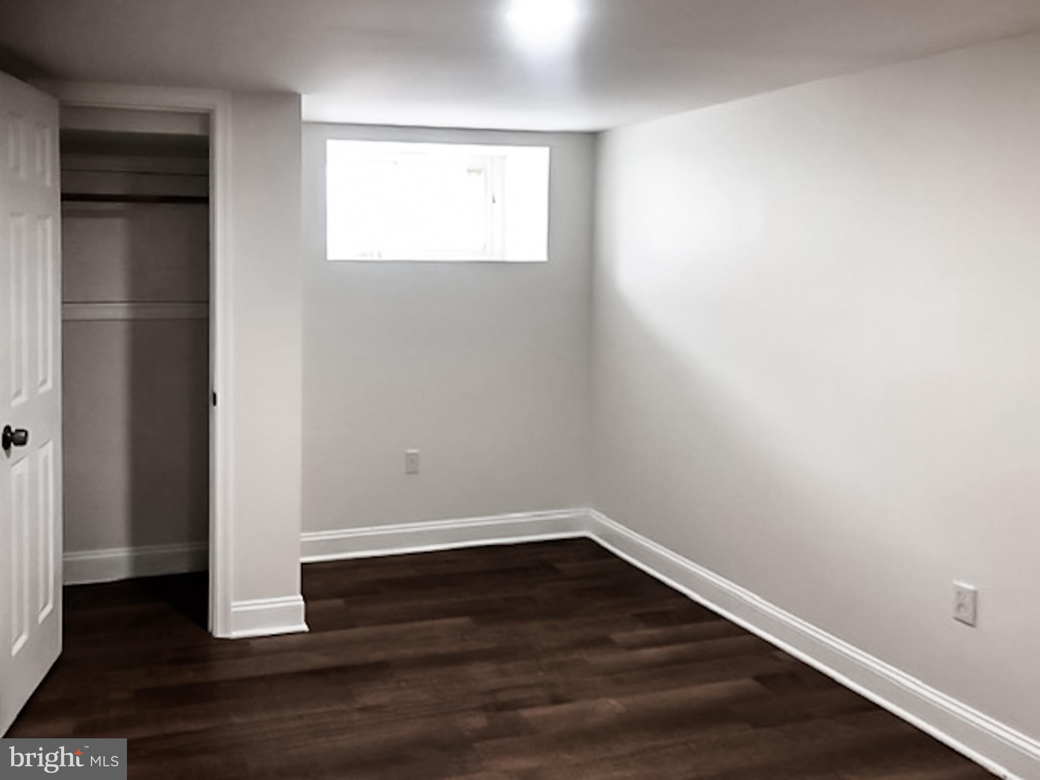 1673 Darley Avenue Baltimore, MD 21213 - Photo 11 of 17 an empty room with wooden floor and windows