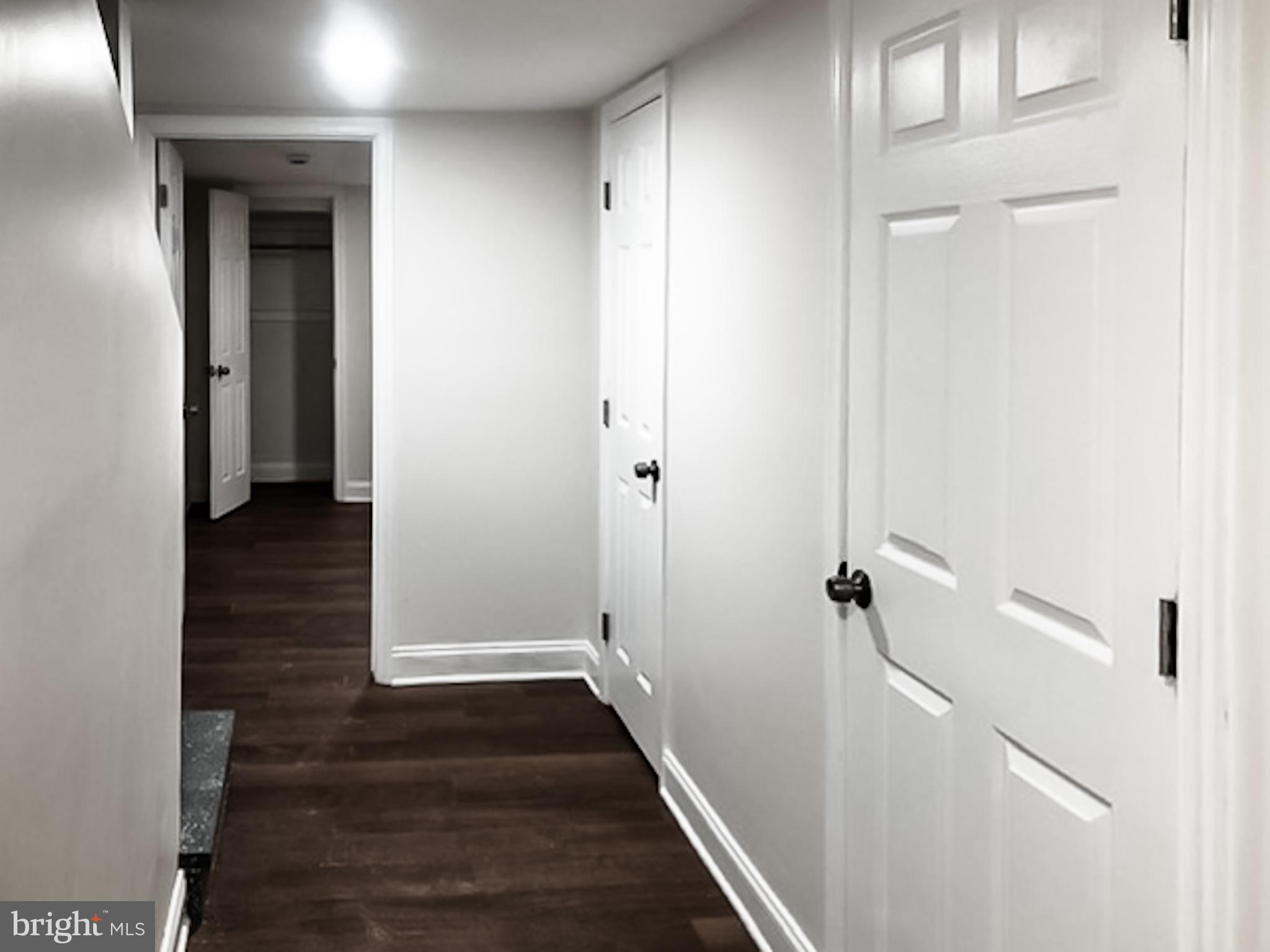 1673 Darley Avenue Baltimore, MD 21213 - Photo 12 of 17 a view of a hallway with wooden floor and staircase