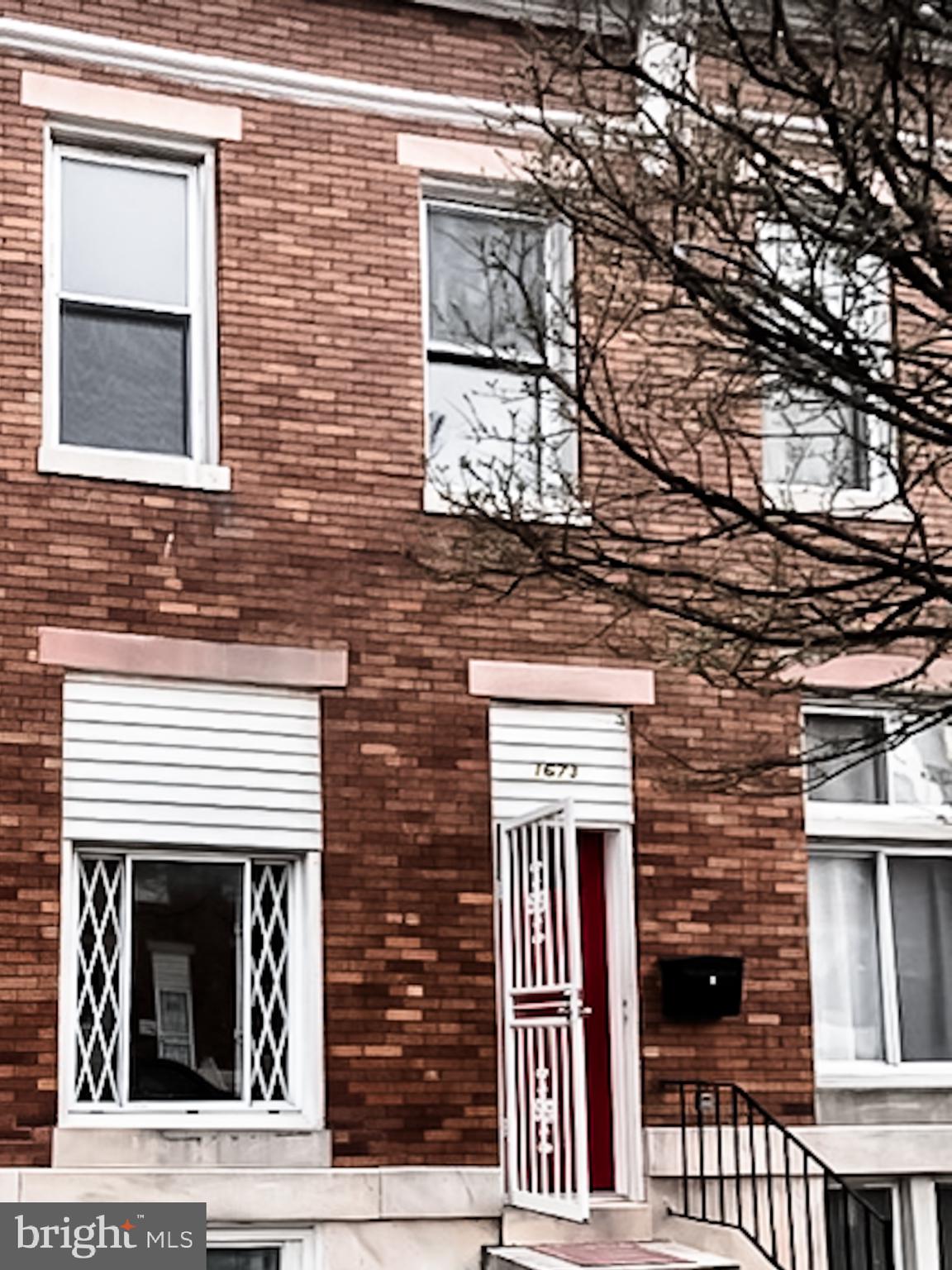 1673 Darley Avenue Baltimore, MD 21213 - Photo 2 of 17 a front view of a house with a door and balcony