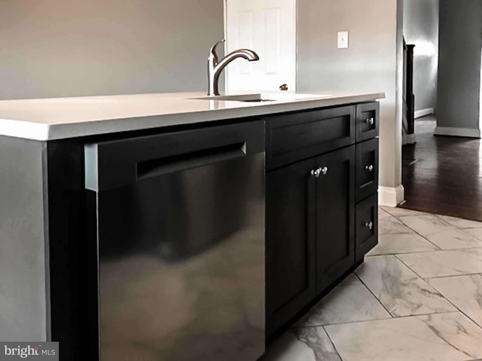 1673 Darley Avenue Baltimore, MD 21213 - Photo 6 of 17 a kitchen with a sink and a mirror