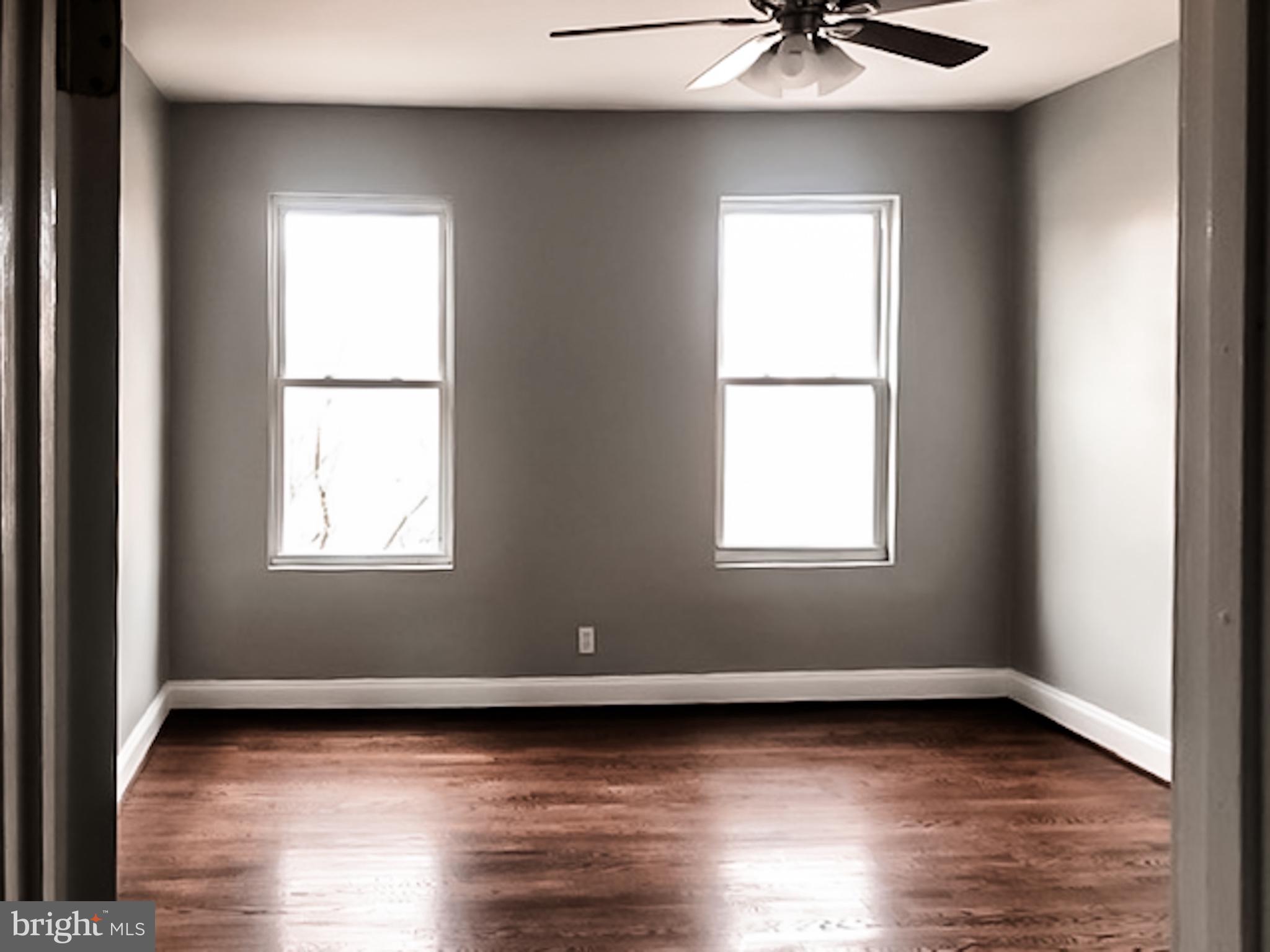 1673 Darley Avenue Baltimore, MD 21213 - Photo 7 of 17 a view of a livingroom with wooden floor and a window