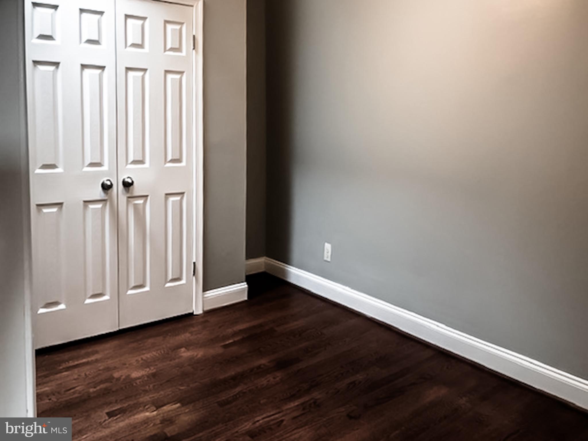 1673 Darley Avenue Baltimore, MD 21213 - Photo 8 of 17 a view of an empty room with wooden floor