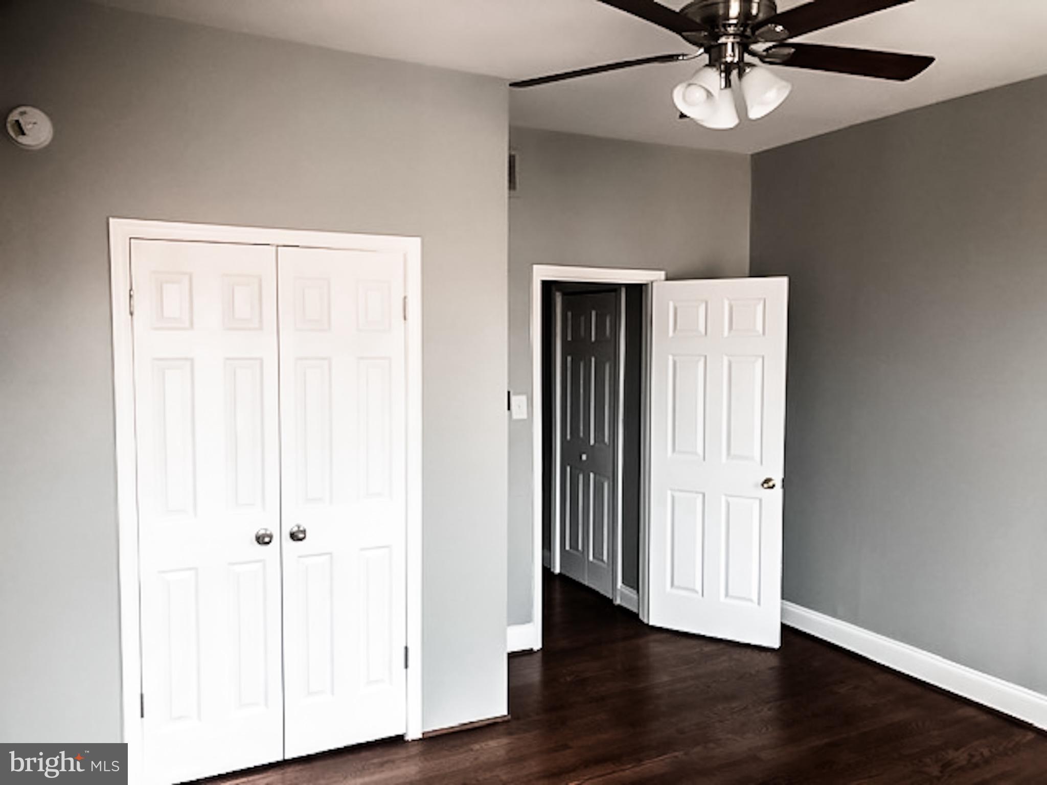 1673 Darley Avenue Baltimore, MD 21213 - Photo 9 of 17 an empty room with wooden floor fan and windows
