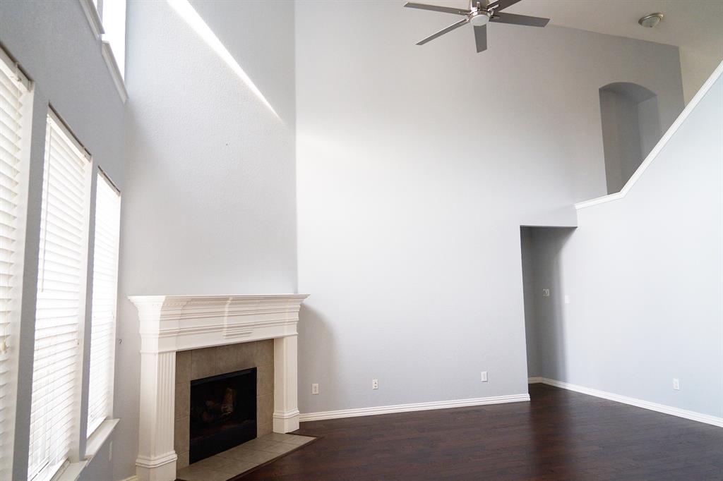 4469 Big Sky Drive Plano, TX 75024 - Photo 12 of 39 a view of a livingroom with wooden floor and a fireplace