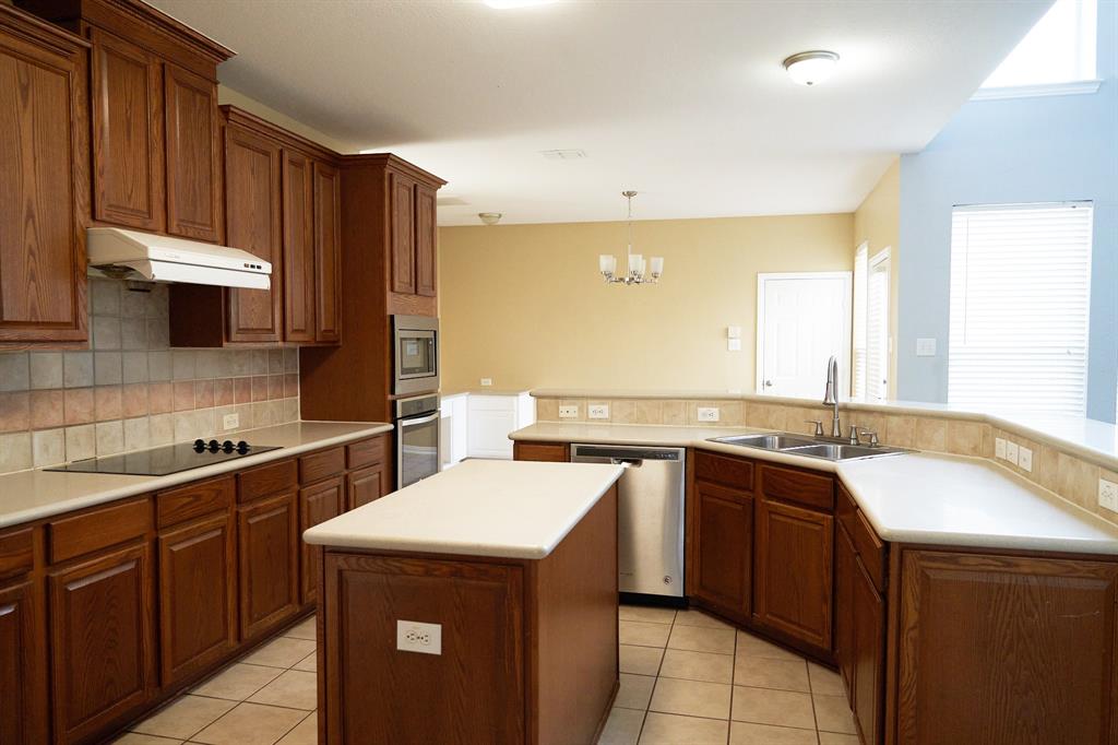 4469 Big Sky Drive Plano, TX 75024 - Photo 13 of 39 a kitchen with a sink stove and cabinets