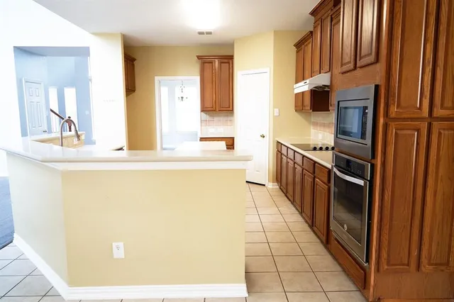 a kitchen with stainless steel appliances a refrigerator and a stove