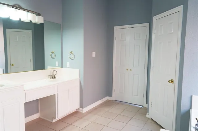 a room with a sink and a mirror