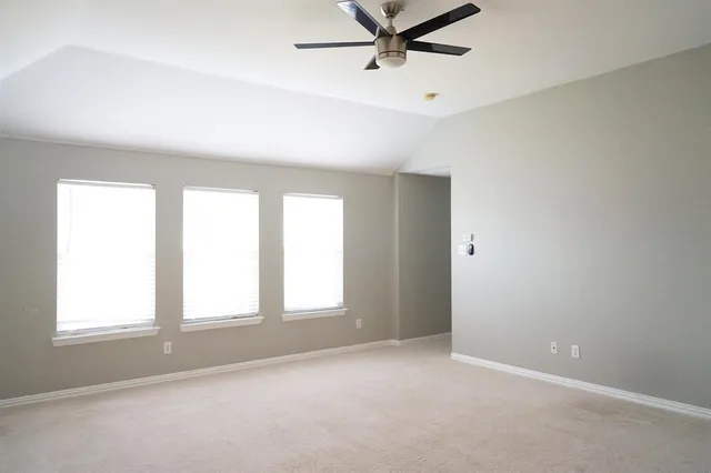 a view of a livingroom with a ceiling fan and window