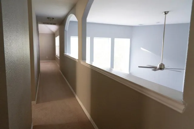 a view of a hallway with windows