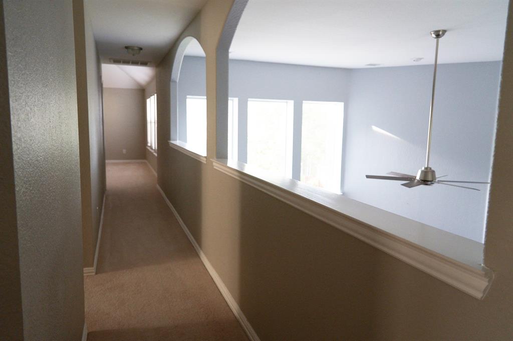 4469 Big Sky Drive Plano, TX 75024 - Photo 31 of 39 a view of a hallway with windows