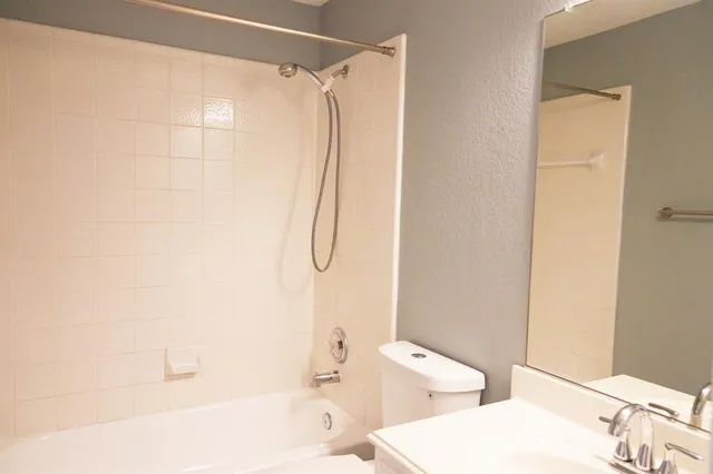 a bathroom with a bathtub and a toilet