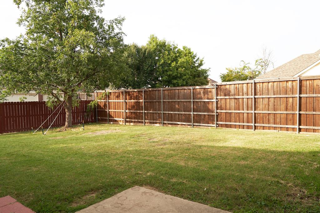 4469 Big Sky Drive Plano, TX 75024 - Photo 36 of 39 a view of a yard with a wooden fence