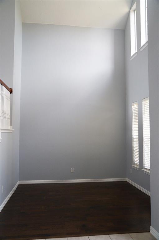 4469 Big Sky Drive Plano, TX 75024 - Photo 8 of 39 an empty room with wooden floor and windows