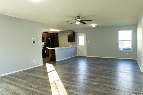 wooden floor in an empty room with a window