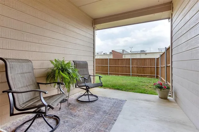a view of a chairs and table in backyard