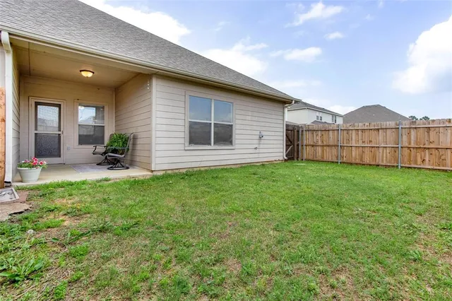 a view of a house with a yard and sitting area