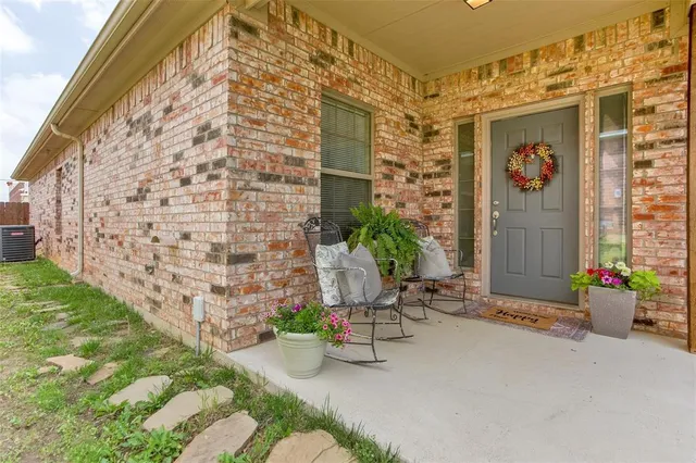 a view of a chairs and table in front of a house