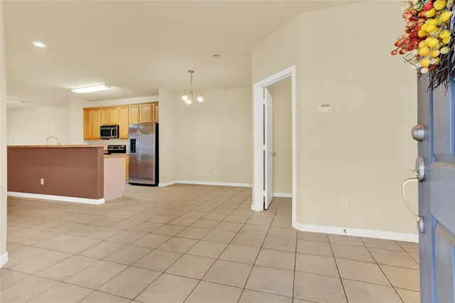 a view of a kitchen with furniture and an empty room