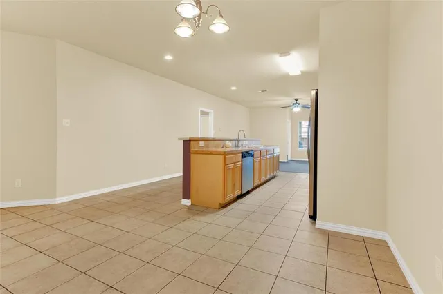 a kitchen with stainless steel appliances a refrigerator and a stove top oven