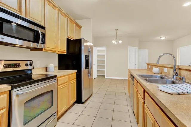 a kitchen with a sink stove and refrigerator