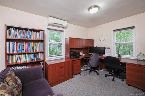 a view of a livingroom with workspace and a window