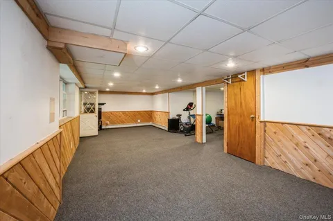 a view of hallway with stairs and furniture