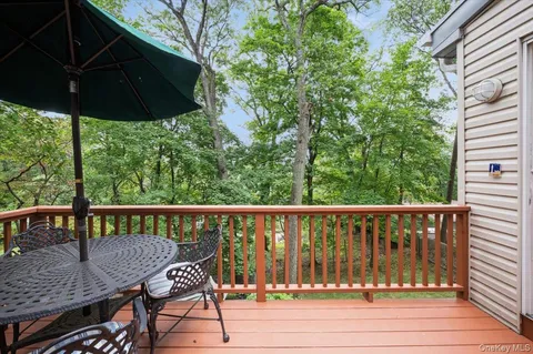 a view of a deck with furniture and wooden deck