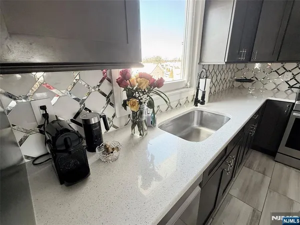 a kitchen with a sink and a mirror