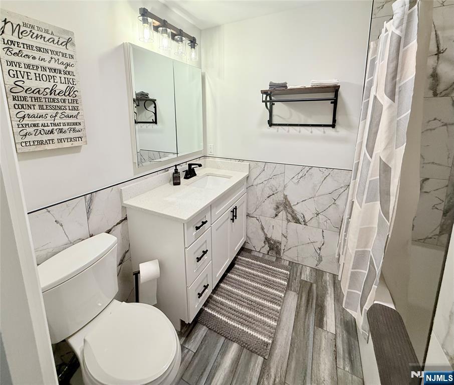 33 Willow Wood Court, Unit 2 East Rutherford, NJ 07073 - Photo 12 of 17 a bathroom with a sink a toilet and shower