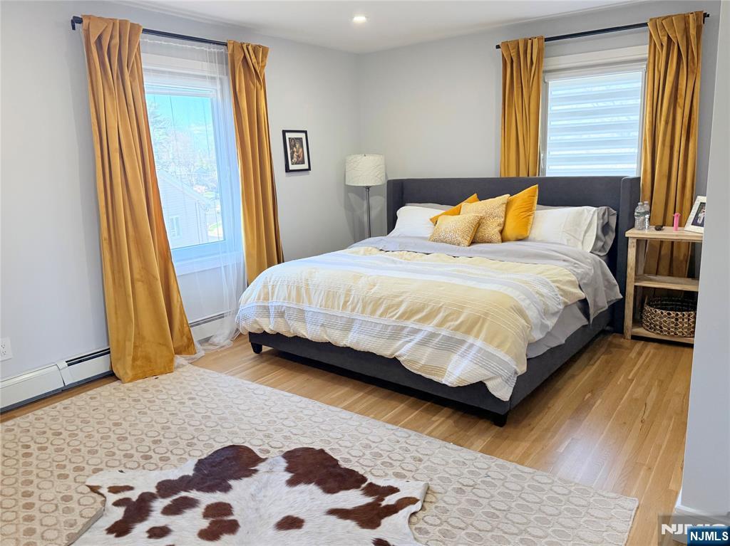 33 Willow Wood Court, Unit 2 East Rutherford, NJ 07073 - Photo 14 of 17 a bedroom with a bed and wooden floor