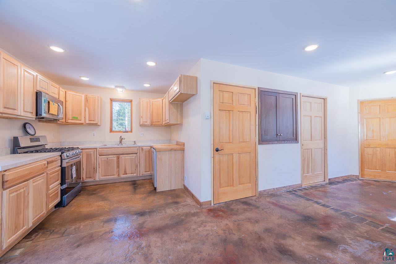 7579 Thumbnail Drive Embarrass, MN 55732 - Photo 4 of 21 Kitchen with stainless steel appliances, sink, and light brown cabinetry