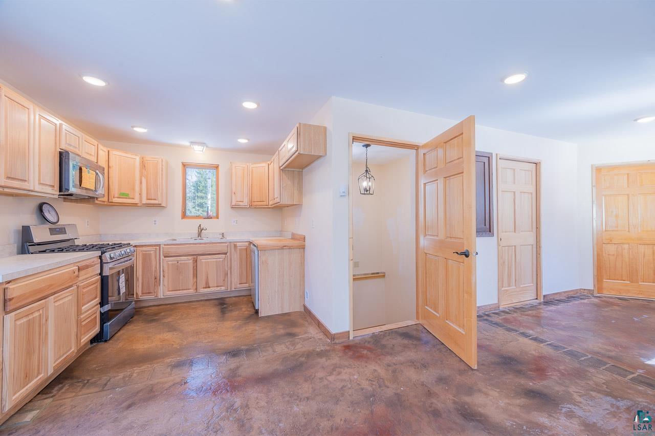 7579 Thumbnail Drive Embarrass, MN 55732 - Photo 5 of 21 Kitchen with light brown cabinets, stainless steel appliances, and sink