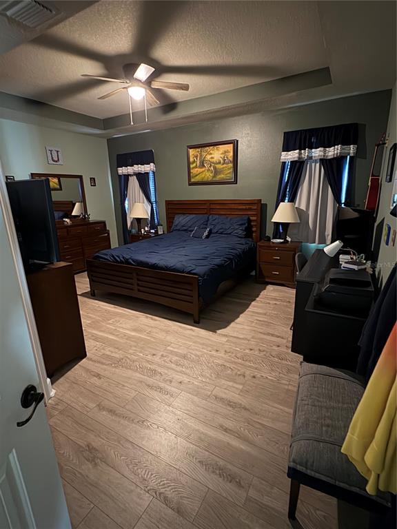 709 Calabria Way Howey-in-the-Hills, FL 34737 - Photo 11 of 26 a bedroom with a bed and furniture