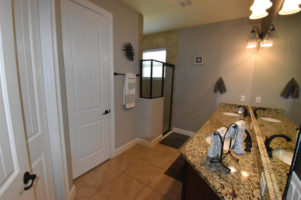 709 Calabria Way Howey-in-the-Hills, FL 34737 - Photo 15 of 26 a bedroom with a bed and dresser