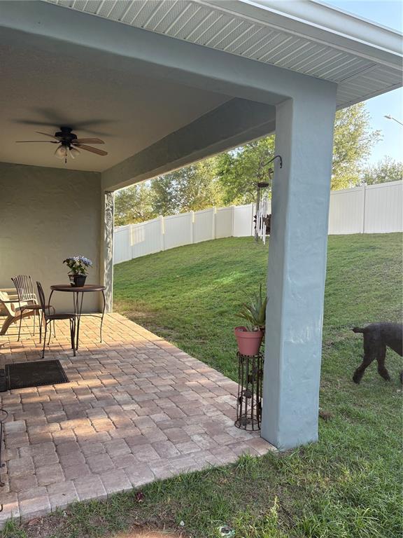 709 Calabria Way Howey-in-the-Hills, FL 34737 - Photo 23 of 26 a view of a porch with chairs and backyard