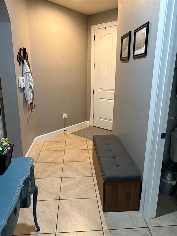 709 Calabria Way Howey-in-the-Hills, FL 34737 - Photo 5 of 26 a bedroom with a bed and wooden floor