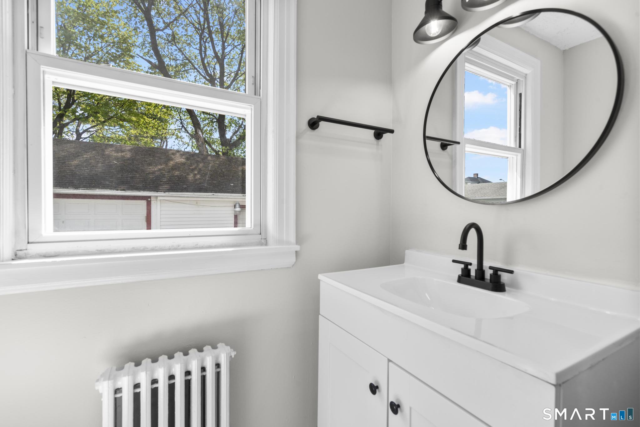 94 3rd Street Hamden, CT 06514 - Photo 11 of 30 a bathroom with a sink and a mirror