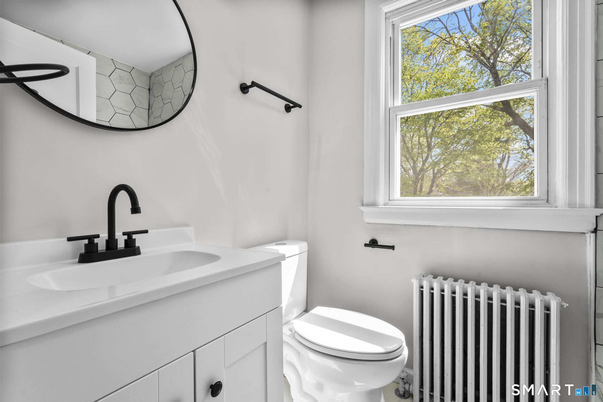 94 3rd Street Hamden, CT 06514 - Photo 15 of 30 a bathroom with a sink and a mirror