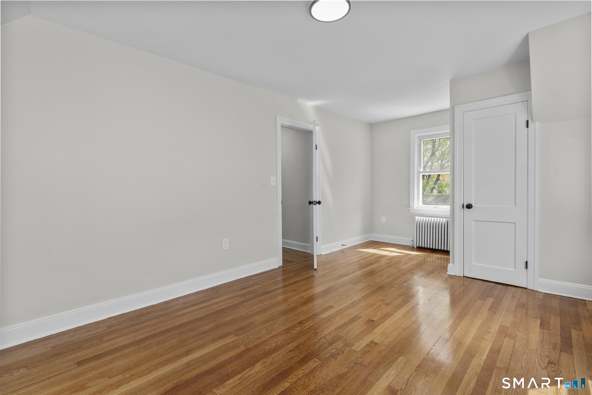 94 3rd Street Hamden, CT 06514 - Photo 19 of 30 a view of an empty room with wooden floor