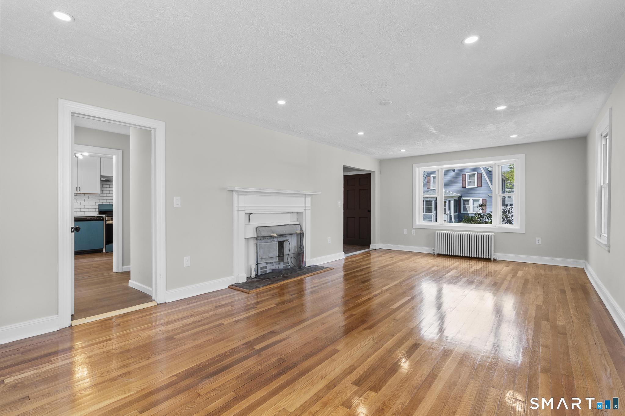 94 3rd Street Hamden, CT 06514 - Photo 7 of 30 a view of an empty room window and wooden floor