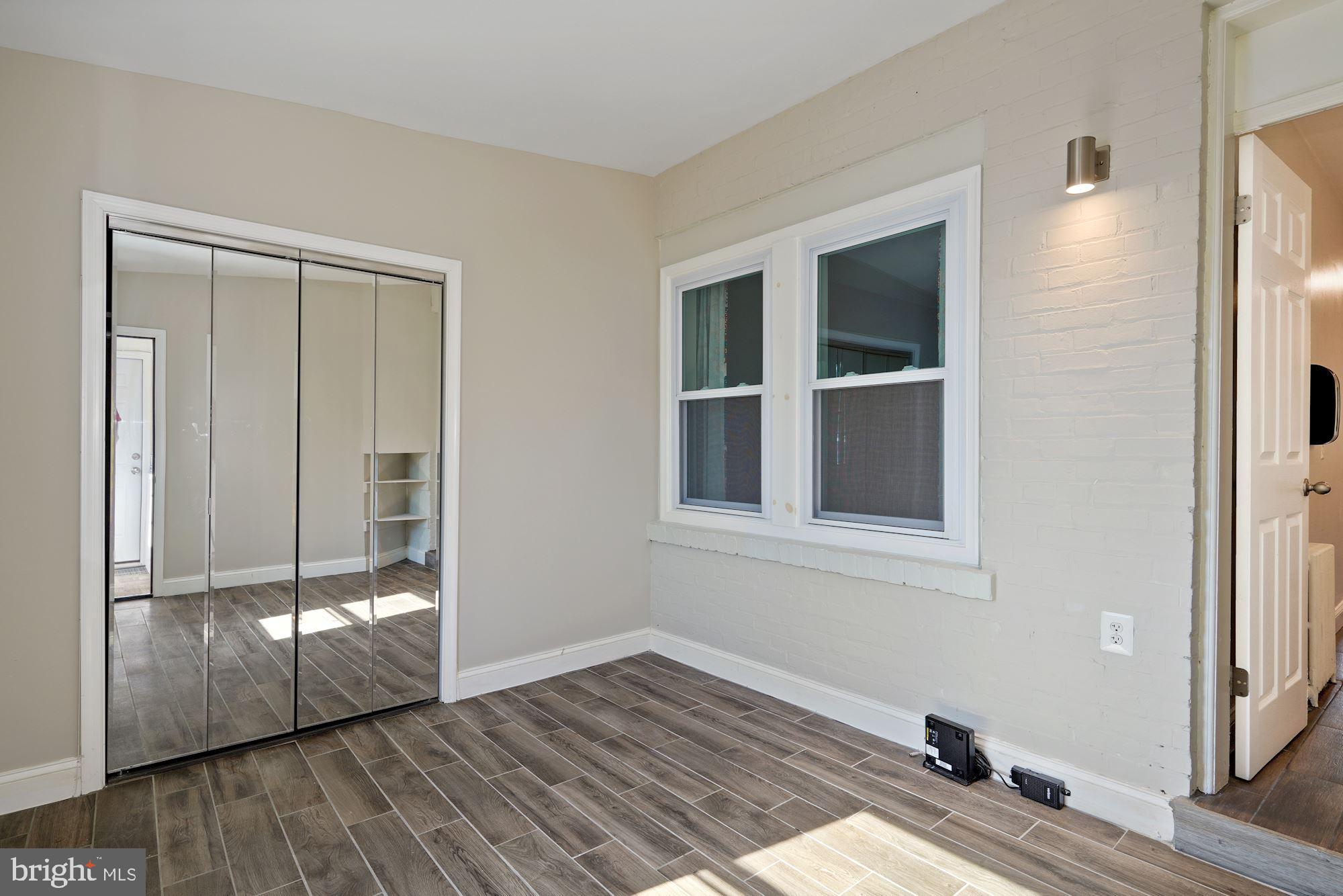 1612 17th Place Southeast Washington, DC 20020 - Photo 11 of 35 an empty room with wooden floor and windows