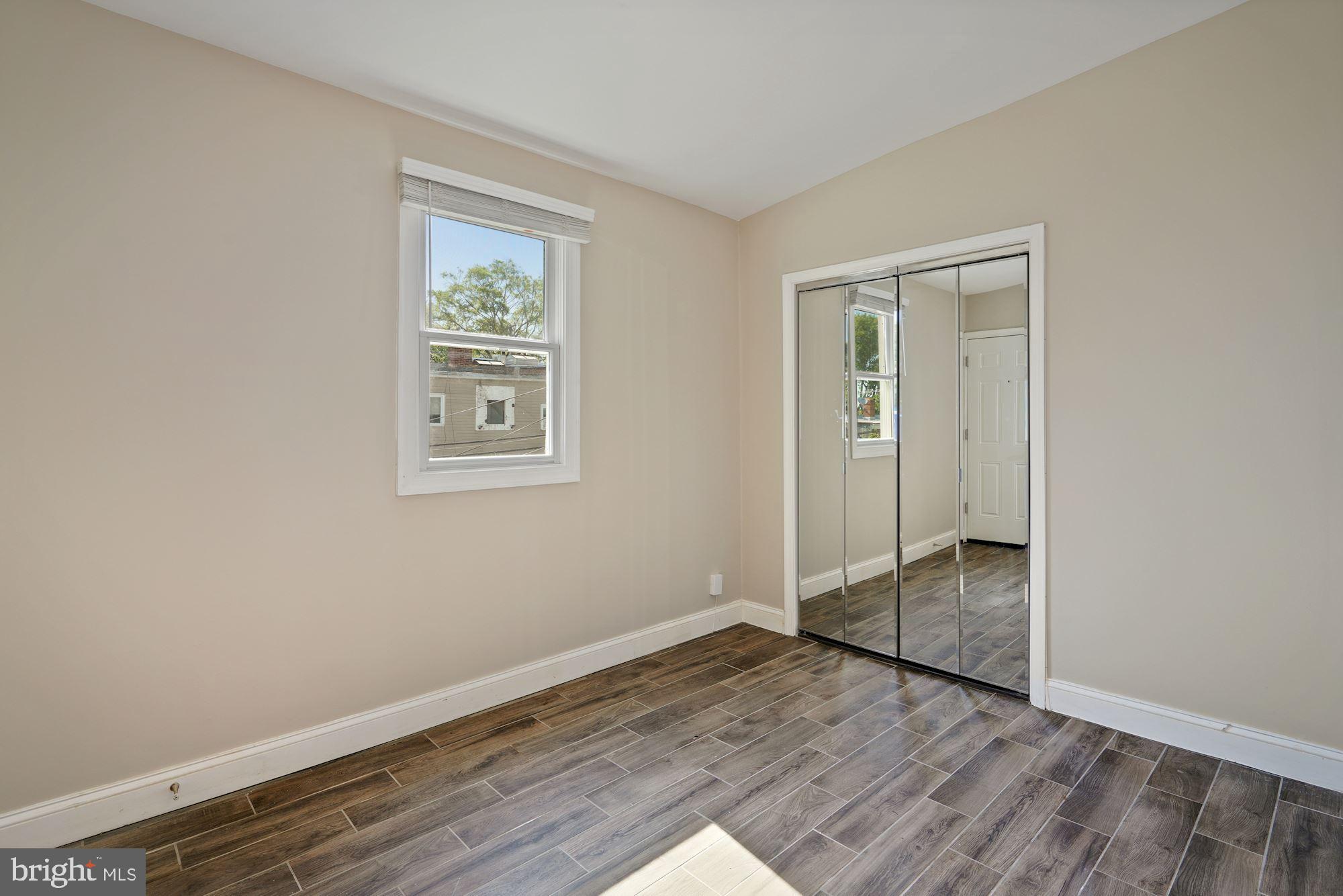 1612 17th Place Southeast Washington, DC 20020 - Photo 12 of 35 an empty room with wooden floor and window